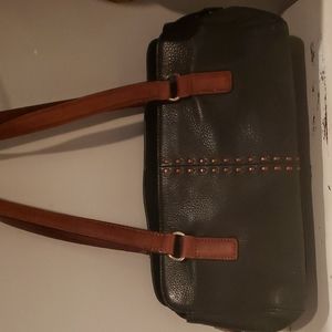 Fossil black leather shoulder bag with brown shoulder straps.